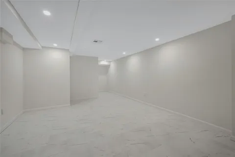 an empty room with a empty space and windows