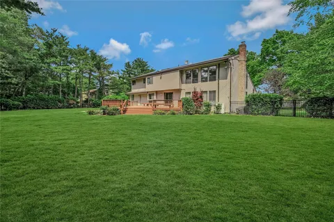 a view of a house with a yard and sitting area