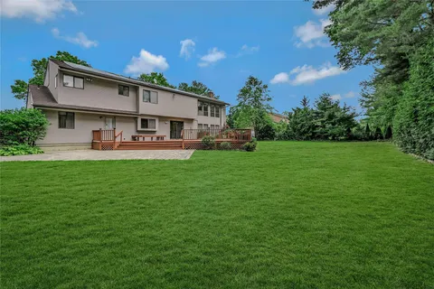 a front view of a house with patio and garden