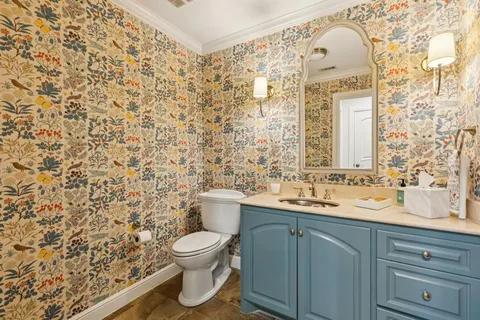 a kitchen with kitchen island granite countertop a stove a sink a oven with a dining table and chairs