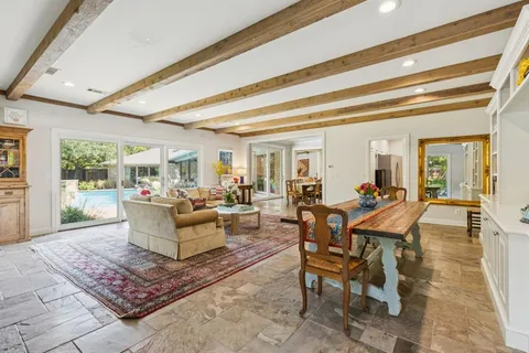 a bedroom with a bed wooden floor and window