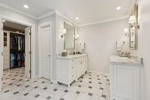 a view of walk in closet with clothes