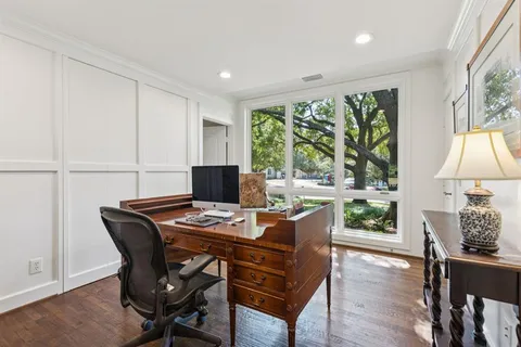 a bedroom with a bed lamp on table and a window