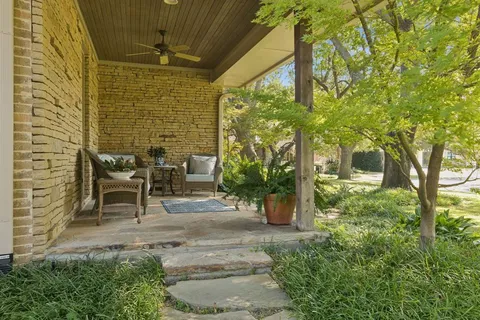 a view of two chairs in the garden