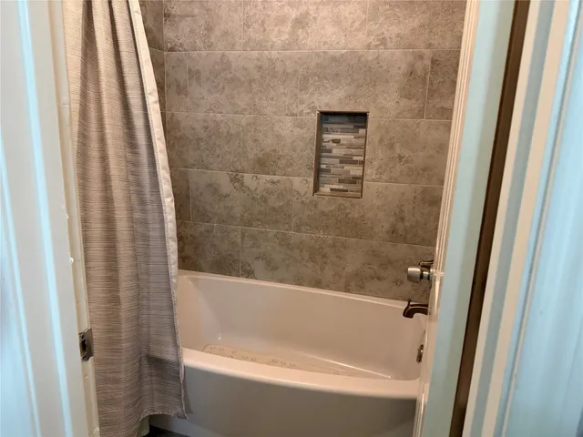 a bathroom with a shower curtain and a sink