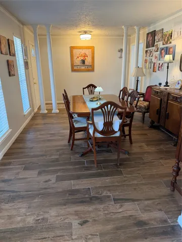 a view of a dining room with furniture window and wooden floor