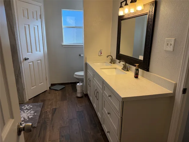 a bathroom with a double vanity sink and mirror
