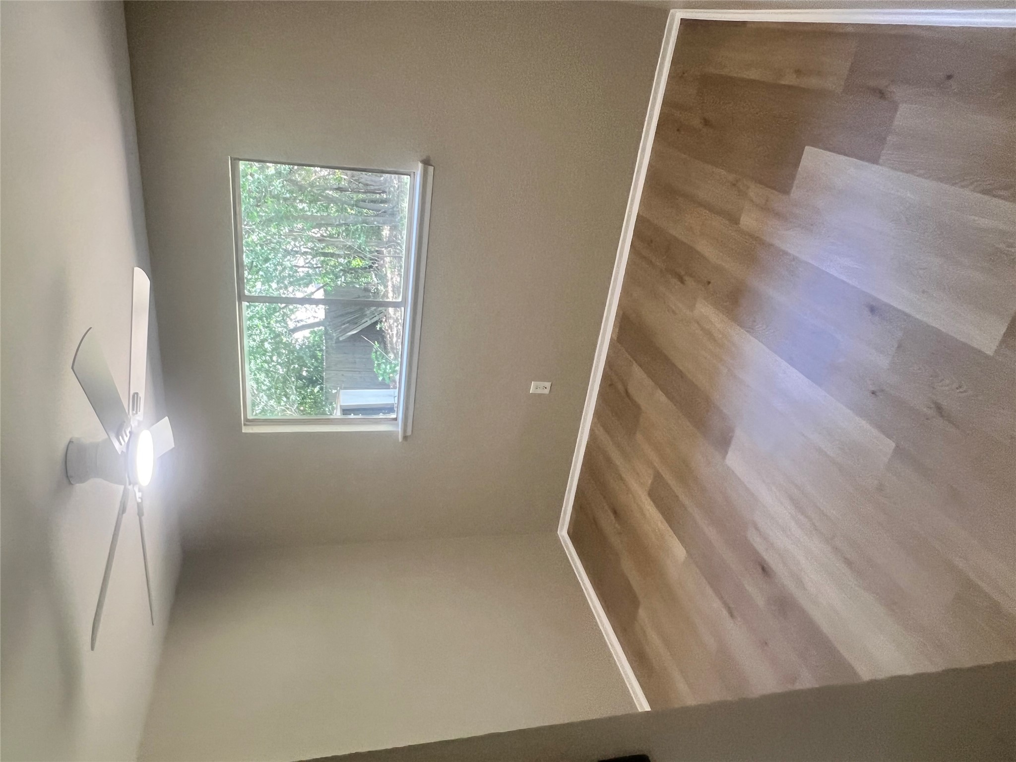 4620 Button Bend Road Austin, TX 78744 - Photo 14 of 22 A quiet bedroom offers durable wood flooring and a refreshing ceiling fan for comfortable living.