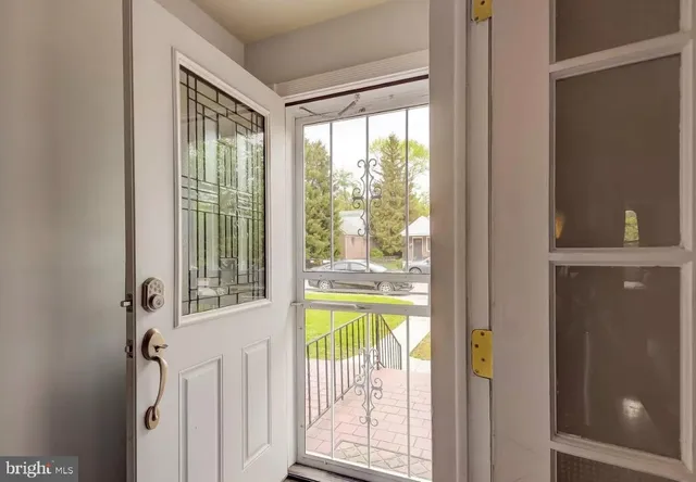 a view of a porch with a furniture and floor to ceiling window