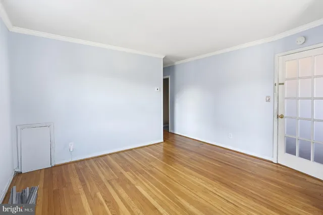 a view of an empty room with wooden floor