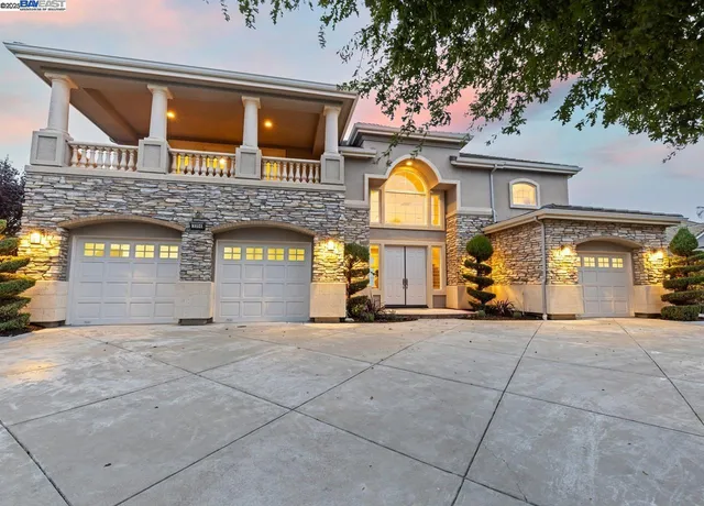 a view of a building with a fountain and a car parked in front of it