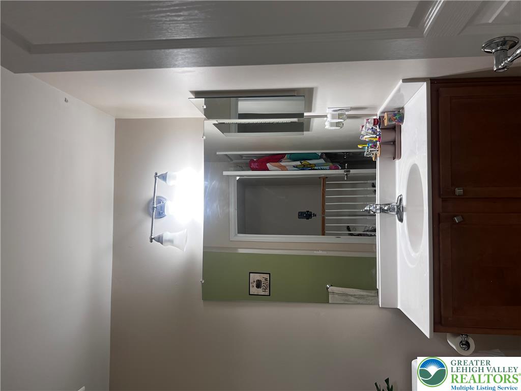8549 Gateway Road Breinigsville, PA 18031 - Photo 24 of 26 A well-appointed vanity with a clean white countertop and ample cabinet storage.