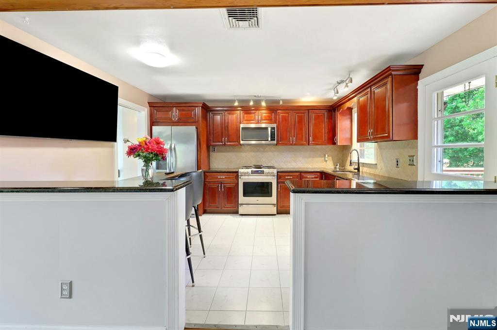 20 Blue Hill Road Norwood, NJ 07648 - Photo 13 of 49 a kitchen with stainless steel appliances a microwave a stove and refrigerator