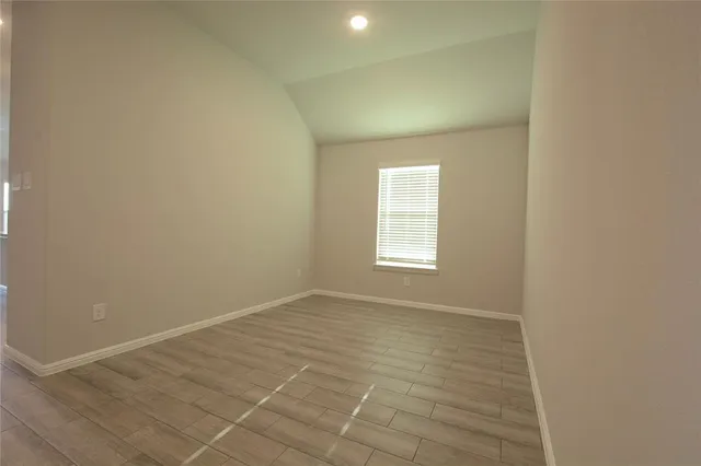 an empty room with a empty space and windows