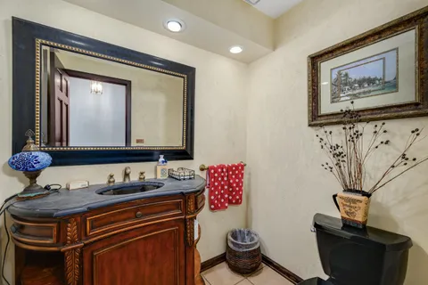 a bathroom with a toilet a sink and a mirror