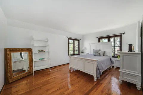 a bedroom with a large bed and a large window