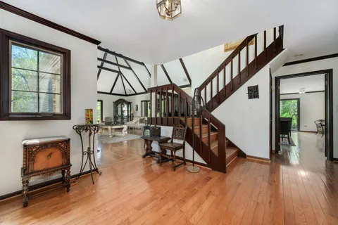 a view of entryway livingroom and hall with wooden floor