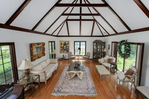a living room with furniture a rug and white walls