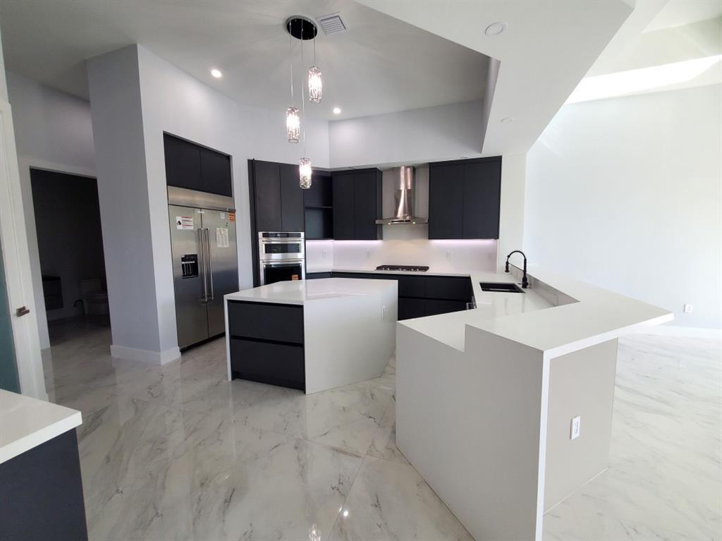 11000 Southwest 30th Court Fort Lauderdale, FL 33328 - Photo 17 of 44 a large white kitchen with a refrigerator a stove top oven and a refrigerator