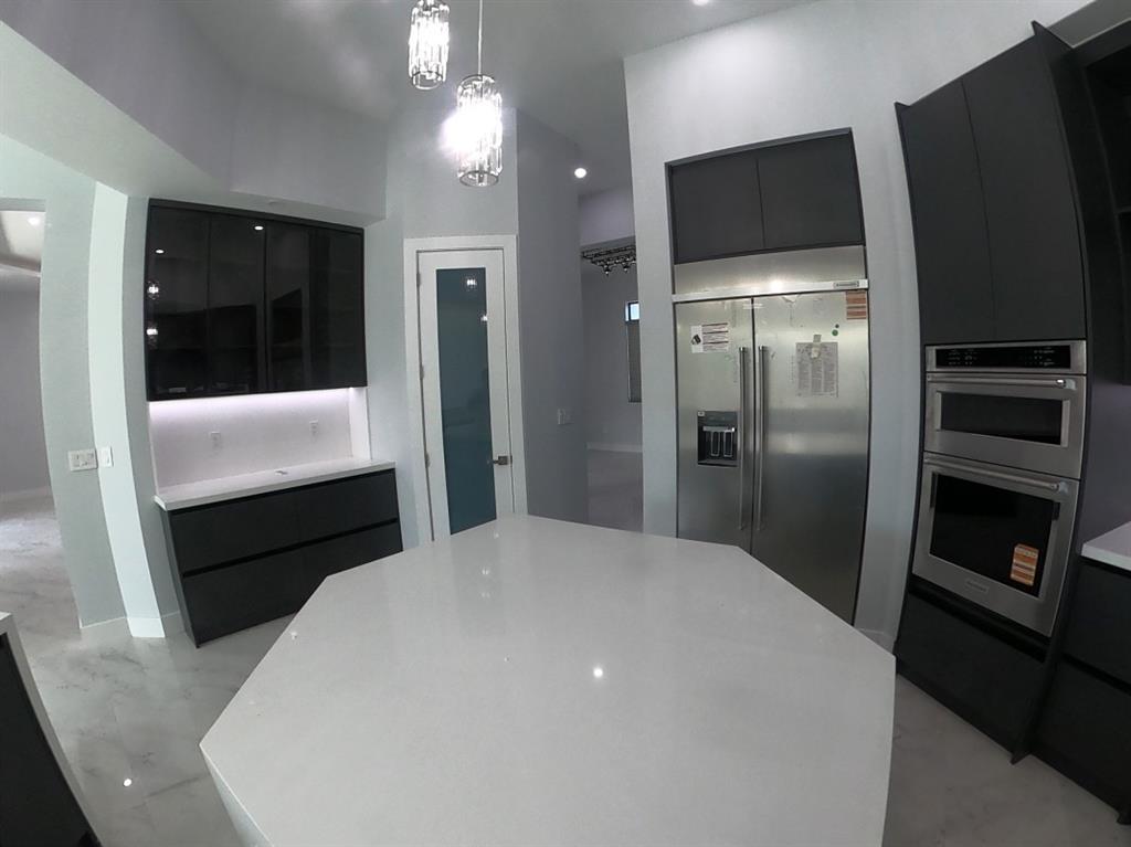 11000 Southwest 30th Court Fort Lauderdale, FL 33328 - Photo 18 of 44 a kitchen with a refrigerator and a television