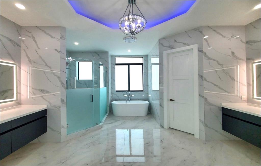 11000 Southwest 30th Court Fort Lauderdale, FL 33328 - Photo 2 of 44 a bathroom with a sink a large mirror and a bathtub