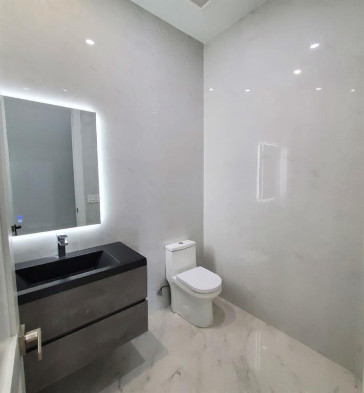 11000 Southwest 30th Court Fort Lauderdale, FL 33328 - Photo 29 of 44 a bathroom with a toilet a sink and mirror