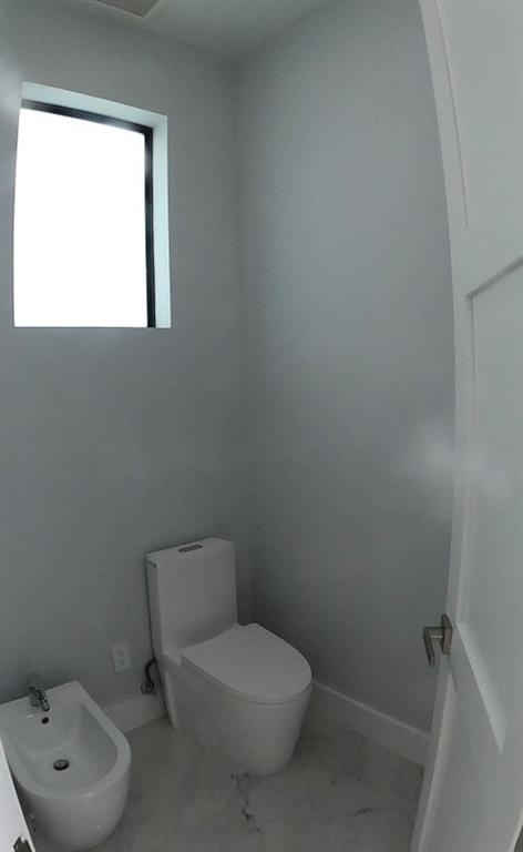 11000 Southwest 30th Court Fort Lauderdale, FL 33328 - Photo 9 of 44 a bathroom with a toilet sink and mirror