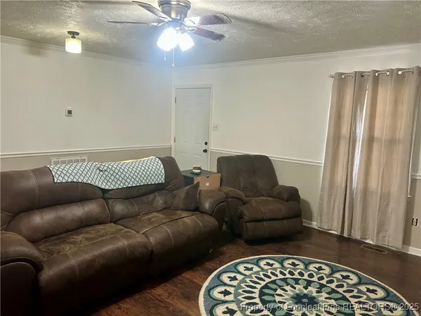 a living room with a couch and a chandelier