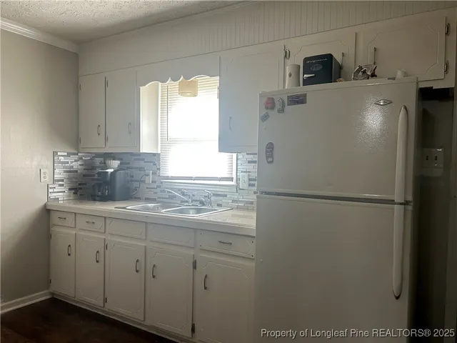 a white refrigerator freezer sitting in a kitchen