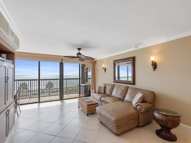 a living room with furniture and large windows