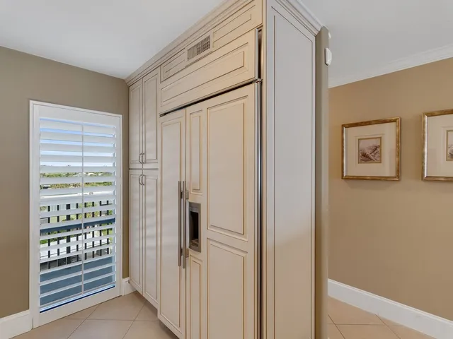 a bedroom with a bed a mirror and a chandelier