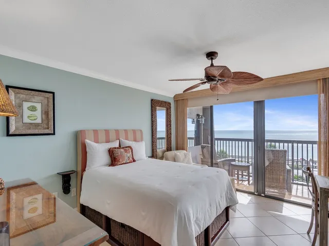 a bedroom with a large bed and a tv