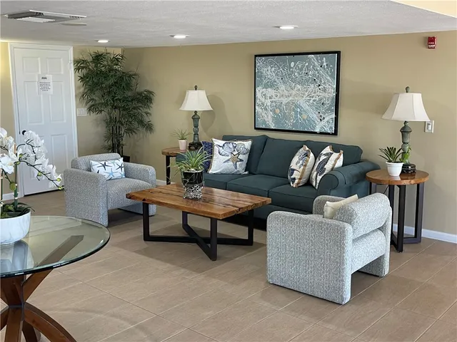 a view of swimming pool with outdoor seating and plants