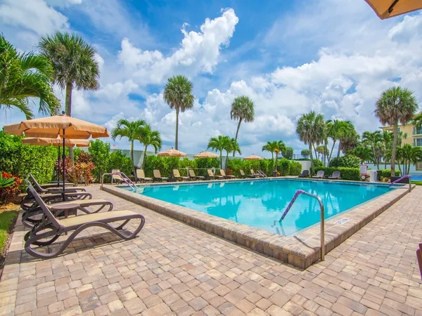 a view of a garden with sitting area and swimming pool