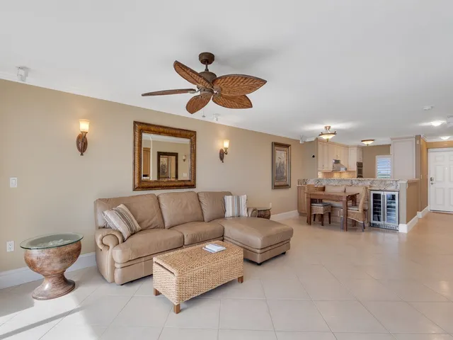 a living room with furniture and a ceiling fan