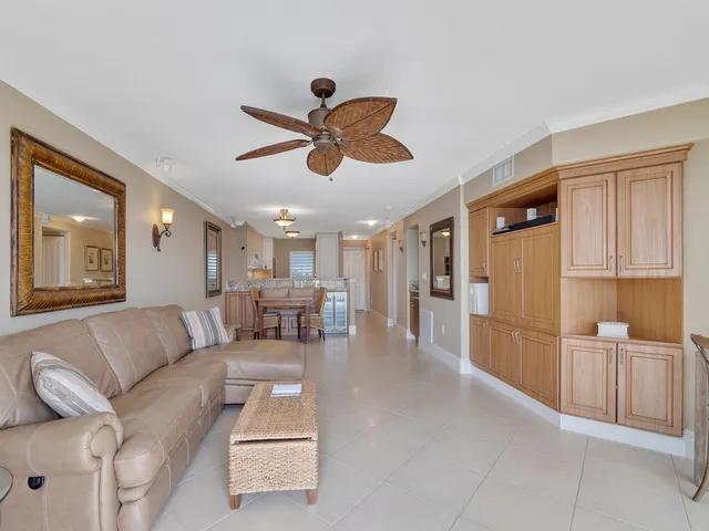 a living room with furniture and a dining table with kitchen view