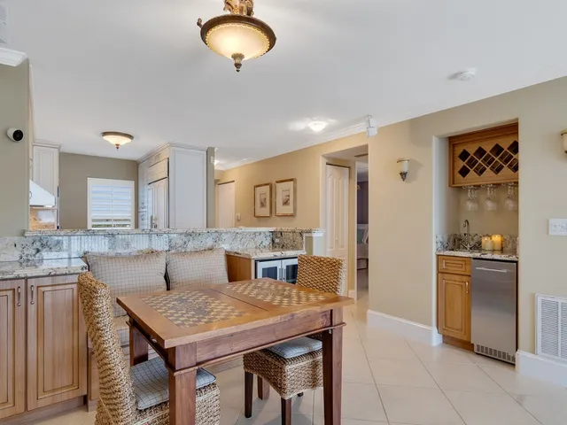 a kitchen with granite countertop a sink a stove and a refrigerator