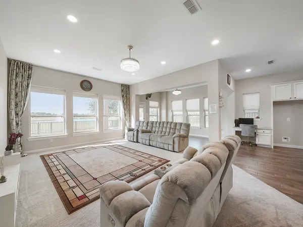 a large kitchen with cabinets wooden floor and stainless steel appliances