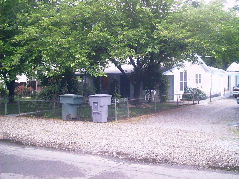 a view of a patio with table and chairs next to a yard