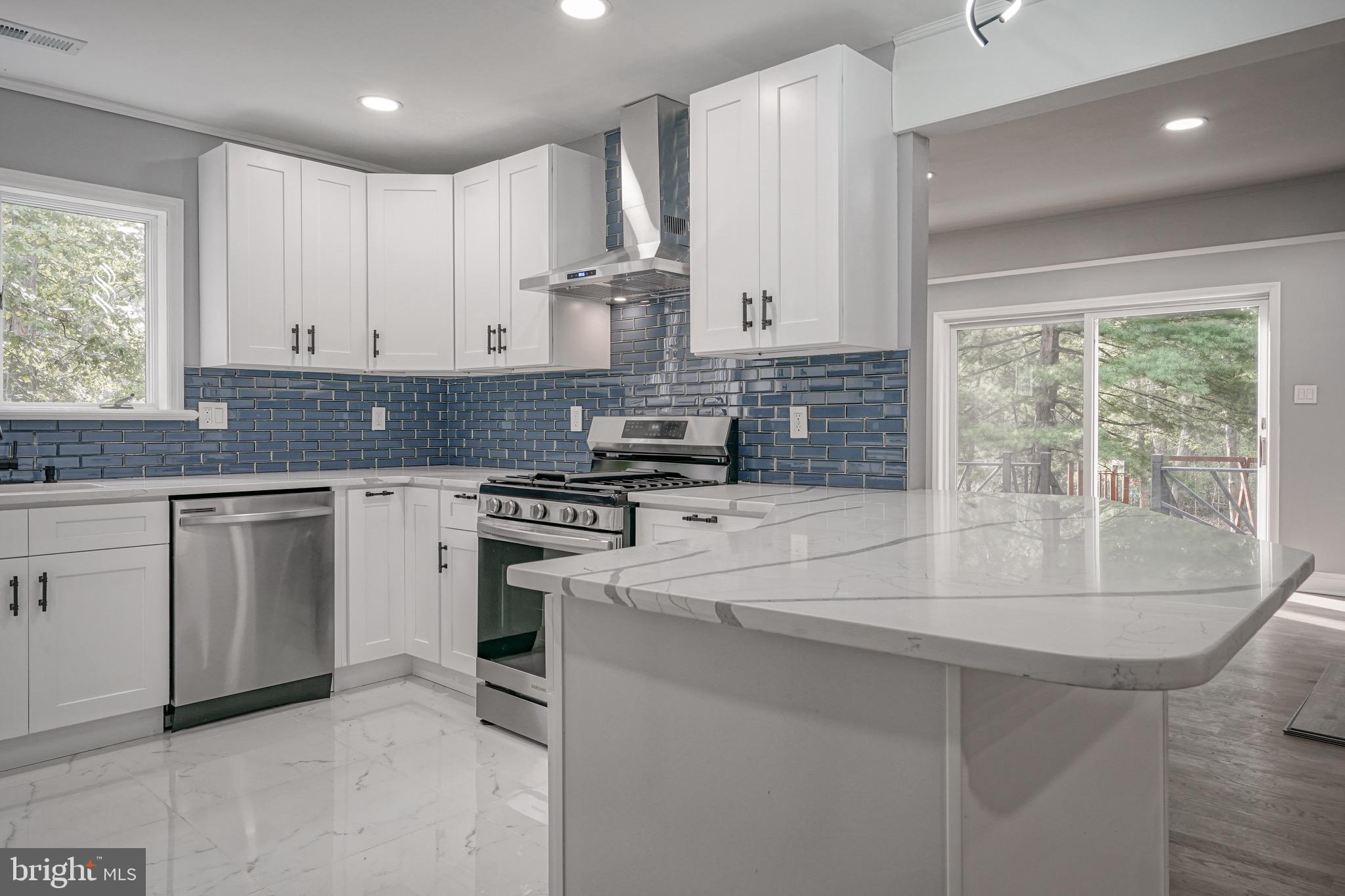 965 Martha Boulevard Atco, NJ 08004 - Photo 25 of 70 a kitchen with stainless steel appliances granite countertop a stove a sink and a refrigerator