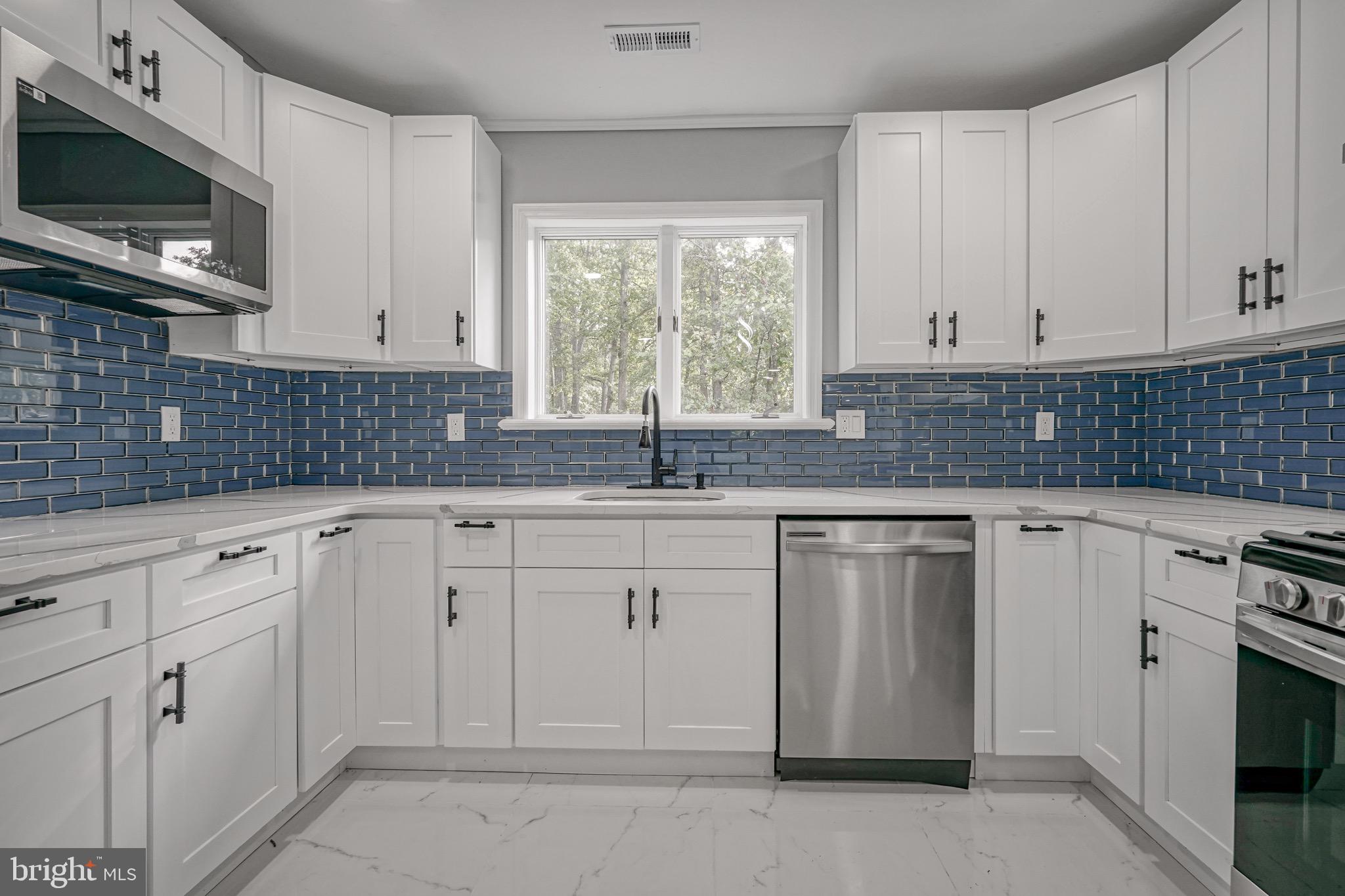 965 Martha Boulevard Atco, NJ 08004 - Photo 6 of 70 a kitchen with granite countertop white cabinets stainless steel appliances and a window