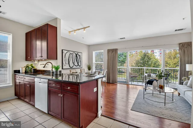 a living room with granite countertop furniture a fireplace and a large window