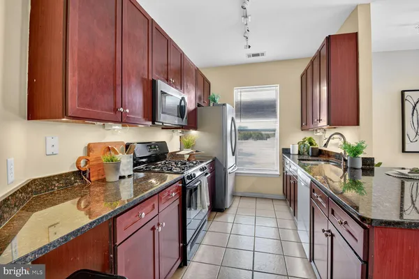 a kitchen with a sink stove and refrigerator