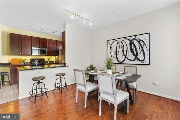 a view of a dining room with furniture window and wooden floor
