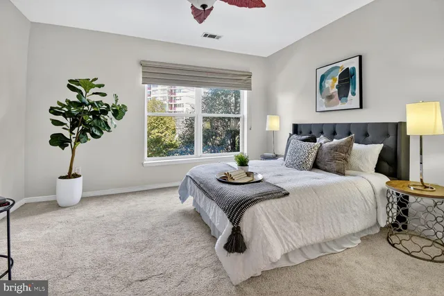 a bedroom with bed and a window