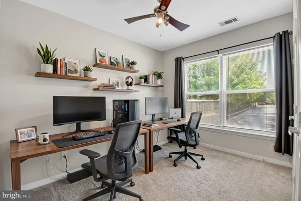 a view of a backyard with table and chairs and potted plants