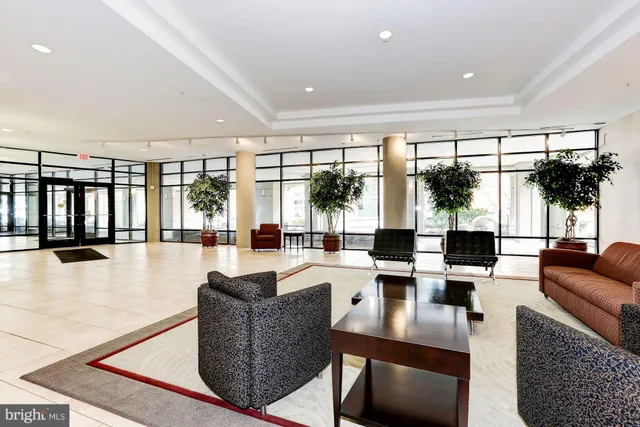 a living room with fireplace furniture and a large window
