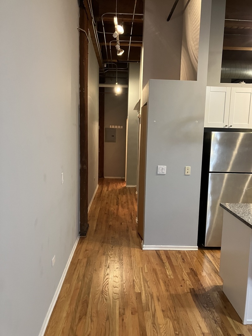 1500 West Monroe Street, Unit 113 Chicago, IL 60607 - Photo 2 of 15 a view of hallway with wooden floor