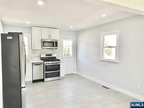 a kitchen with a refrigerator stove and microwave