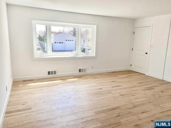 a view of a room with wooden floor and cabinet